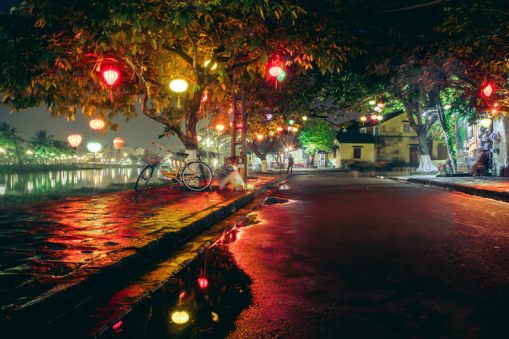 A-typically-crowded-riverside-street-finds-a-brief-moment-of-peace-at-night-in-Hội-An,-Vietnam